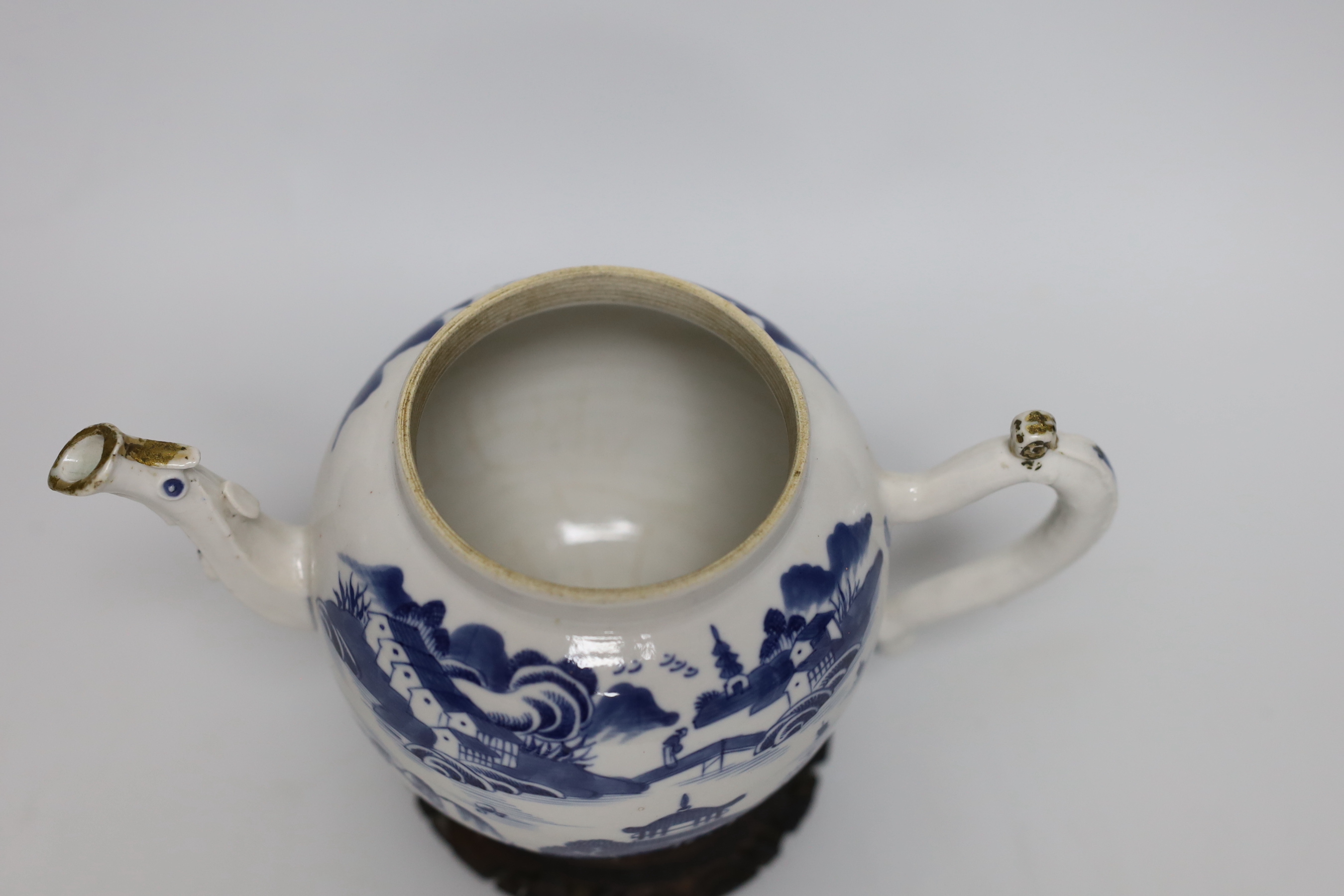 An 18th century Chinese blue and white teapot and cover, with hardwood stand, 19cm total height